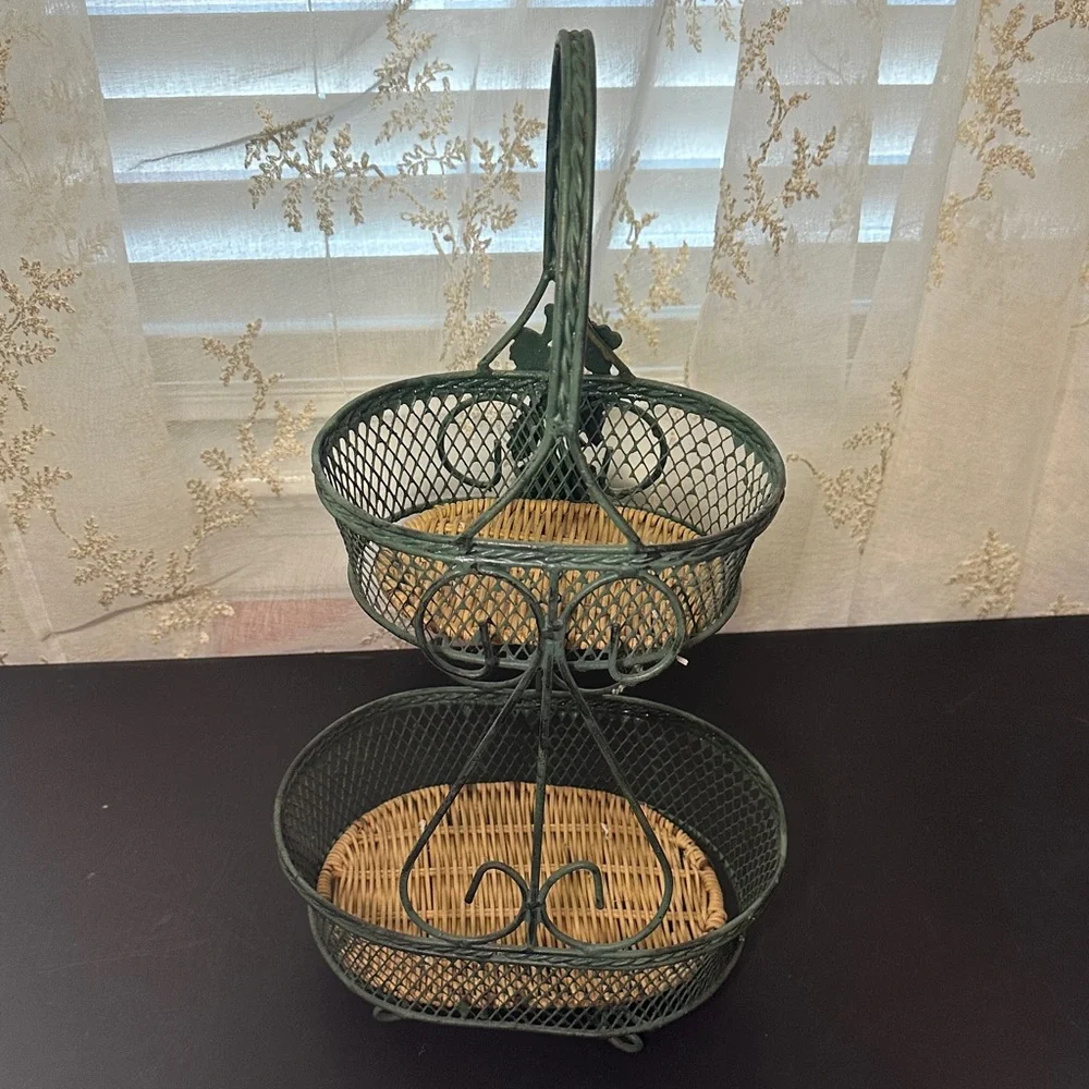 Wire Basket stand made of green-painted metal wire with a woven wicker base